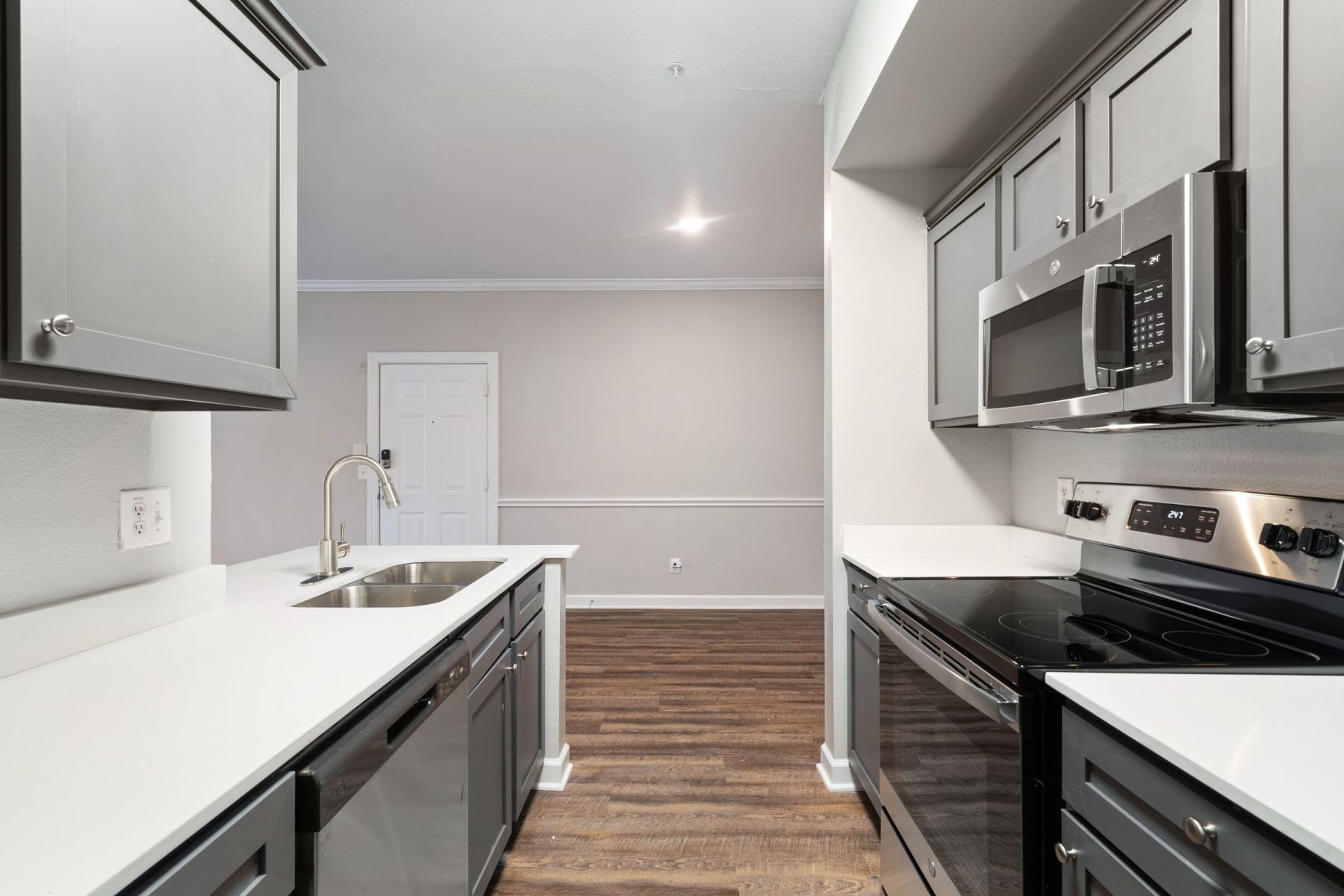 Luxury apartment kitchen with stainless steel appliances, granite countertops, and lots of storage space
